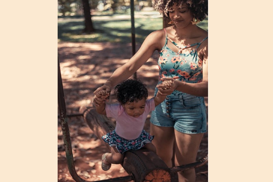 Holding Tiny Hands: A Moment of Motherhood in Motion