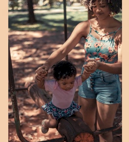 Holding Tiny Hands: A Moment of Motherhood in Motion